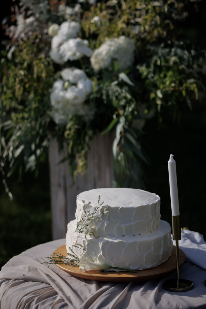 wedding white cake with green and white plants, flowers